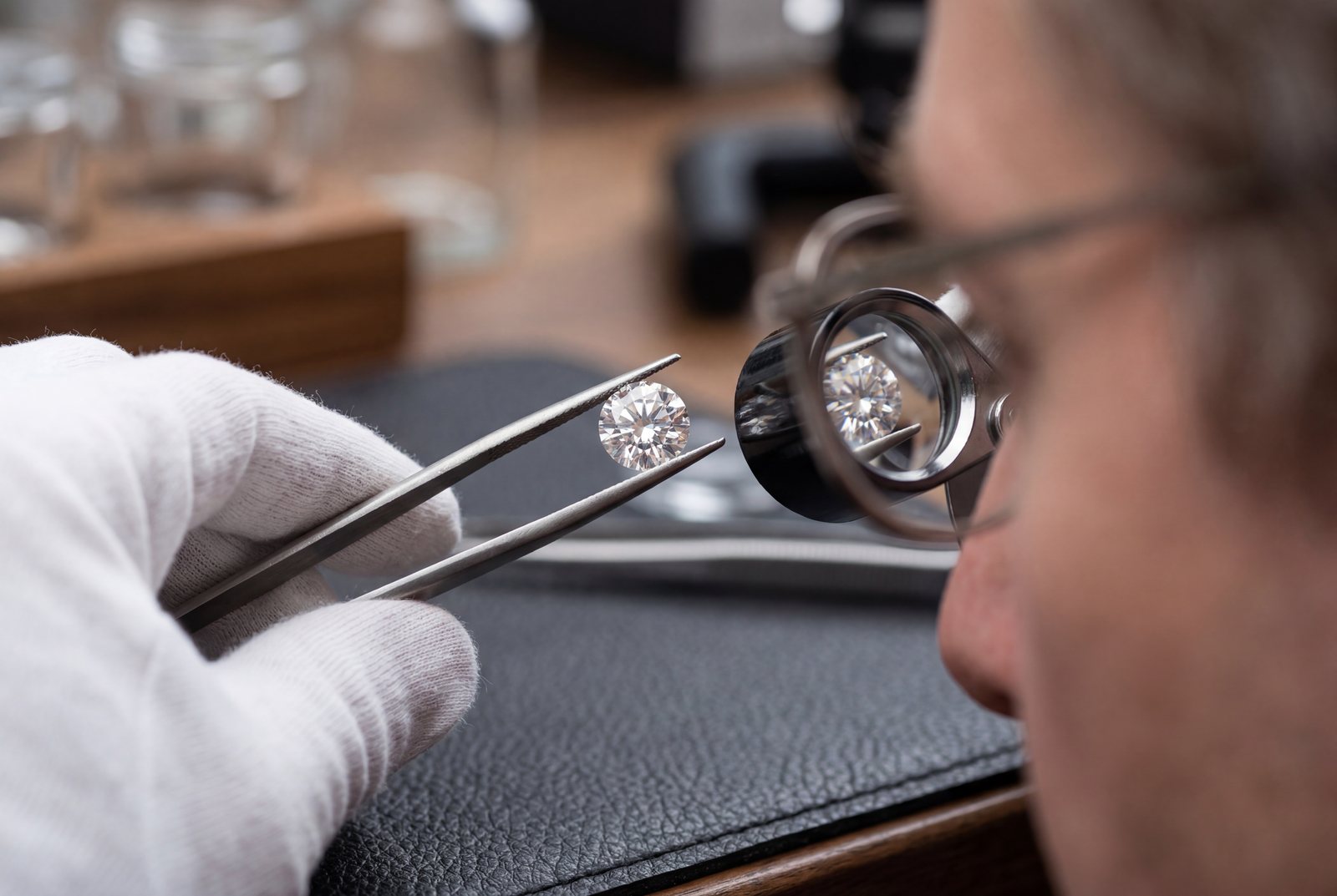 Diamond held with tweezers for review